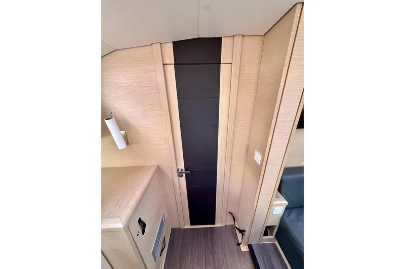 Slide: The Image of Interior of 2018 Jeanneau 54 yacht, featuring sleek wooden paneling and modern design elements. - 96