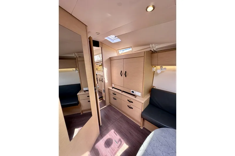 Slide: The Image of Interior of 2018 Jeanneau 54 yacht, featuring modern wood cabinetry and seating. - 106