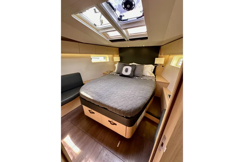 Slide: The Image of Luxurious cabin interior of 2018 Jeanneau 54 yacht with skylight and cozy bedding. - 105