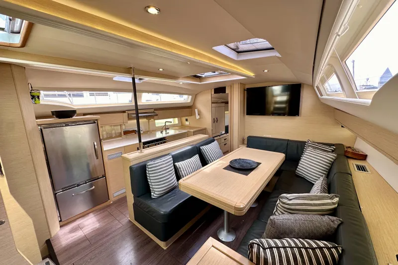 Slide: The Image of Luxurious interior of a 2018 Jeanneau 54 yacht with modern kitchen and cozy seating area. - 74