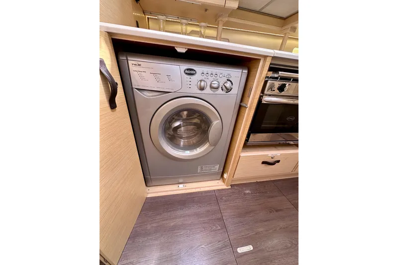 Slide: The Image of Washing machine in 2018 Jeanneau 54 yacht's wooden interior kitchen. - 90