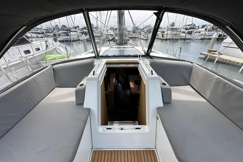 Slide: The Image of 2018 Jeanneau 54 yacht cockpit with spacious seating and marina view. - 60