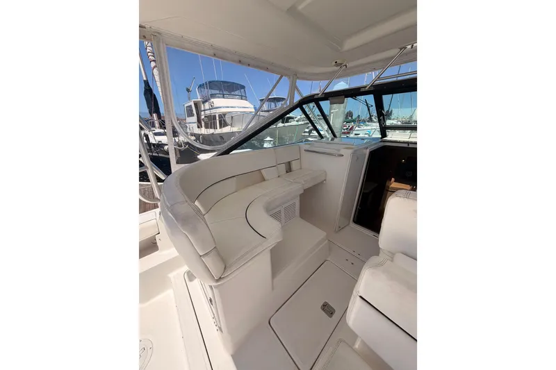 Slide: The Image of 2005 Tiara Yachts 2900 Open Classic interior with white seating and helm view. - 28