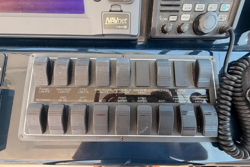 Slide: The Image of Close-up of a boat control panel with toggle switches and a radio. - 35