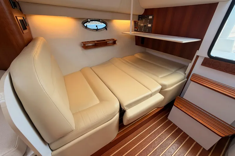 Slide: The Image of Interior of 2005 Tiara Yachts 2900 Open Classic, featuring beige seating and wooden accents. - 59