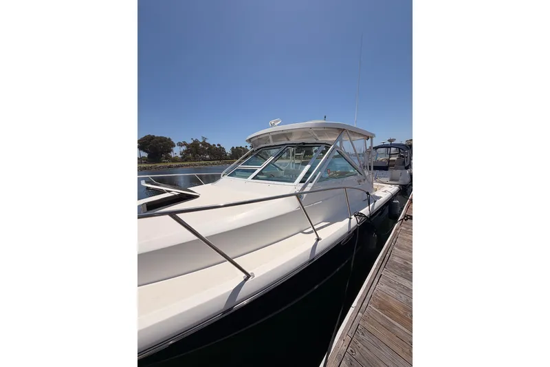 Slide: The Image of 2005 Tiara Yachts 2900 Open Classic docked, showcasing sleek design and spacious deck. - 4