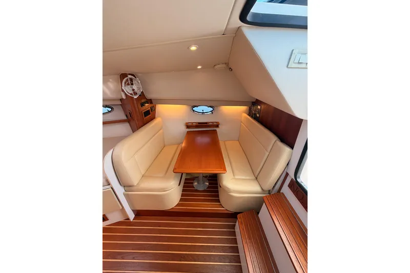 Slide: The Image of Interior of 2005 Tiara Yachts 2900 Open Classic, featuring elegant seating and wooden table. - 57