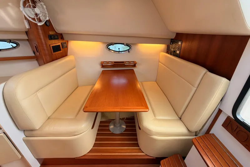 Slide: The Image of Interior of 2005 Tiara Yachts 2900 Open Classic with cozy seating and wooden table. - 58