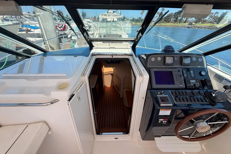 Slide: The Image of 2005 Tiara Yachts 2900 Open Classic cockpit with navigation controls and cabin entrance. - 43