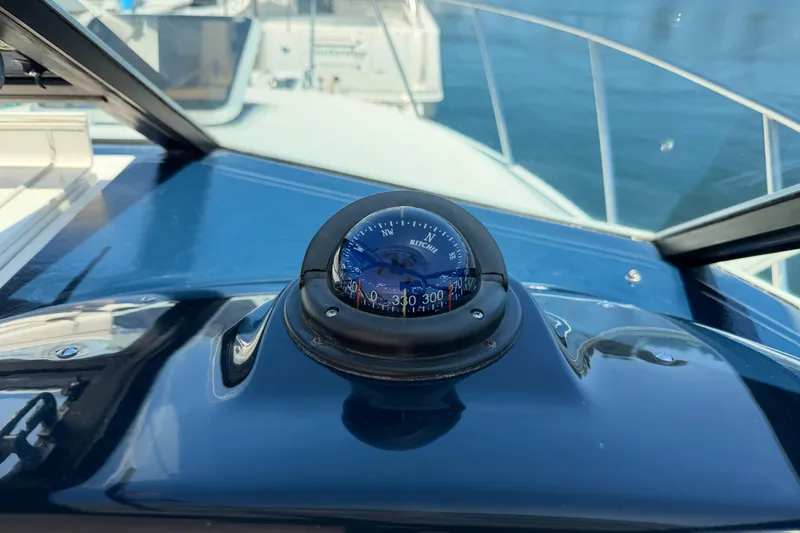 Slide: The Image of Compass on 2005 Tiara Yachts 2900 Open Classic dashboard, with marina view. - 42