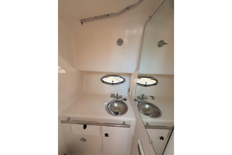 Slide: The Image of 2005 Tiara Yachts 2900 Open Classic bathroom with sink and mirror. - 53