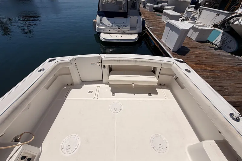 Slide: The Image of 2005 Tiara Yachts 2900 Open Classic boat deck at marina, featuring spacious seating. - 12