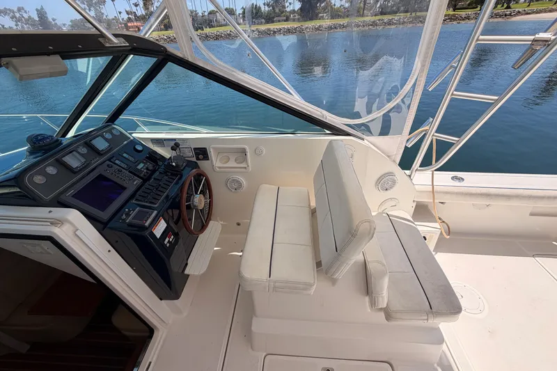 Slide: The Image of 2005 Tiara Yachts 2900 Open Classic cockpit with helm, seating, and water view. - 29