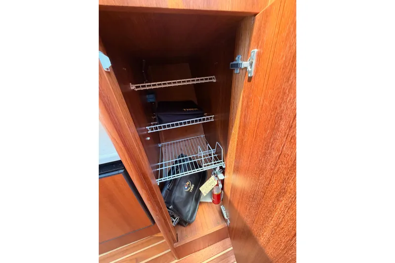 Slide: The Image of Wooden cabinet interior with wire shelves on a 2005 Tiara Yachts 2900 Open Classic. - 66