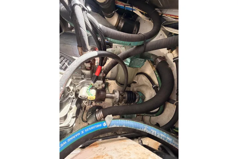 Slide: The Image of Engine compartment of a 2005 Tiara Yachts 2900 Open Classic, showing hoses and mechanical components. - 81