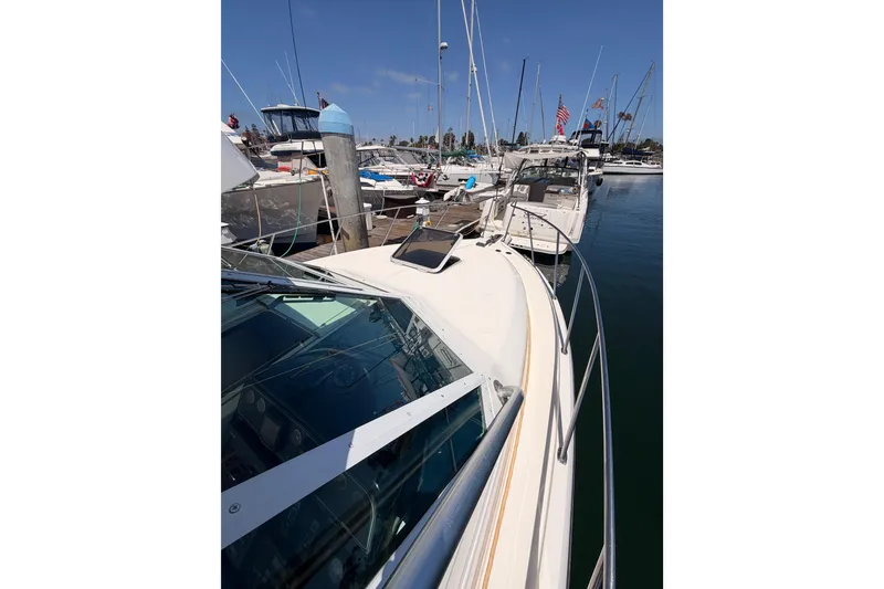 Slide: The Image of 2005 Tiara Yachts 2900 Open Classic docked at marina, showcasing sleek design and craftsmanship. - 20