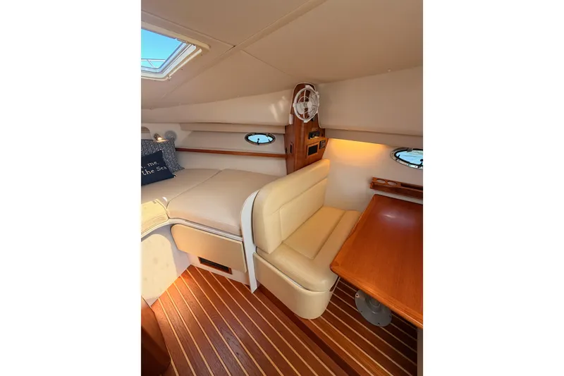 Slide: The Image of Interior of 2005 Tiara Yachts 2900 Open Classic, featuring cozy seating and wooden accents. - 60