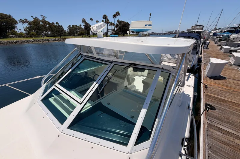 Slide: The Image of 2005 Tiara Yachts 2900 Open Classic docked, showcasing sleek design and spacious cockpit. - 23