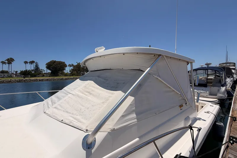 Slide: The Image of 2005 Tiara Yachts 2900 Open Classic docked, featuring sleek design and covered cockpit. - 76