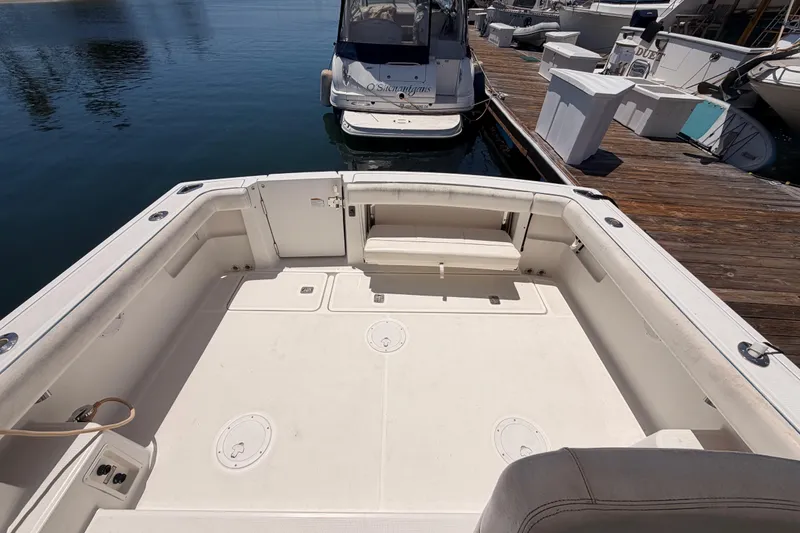 Slide: The Image of 2005 Tiara Yachts 2900 Open Classic boat docked, showcasing spacious deck and seating area. - 74