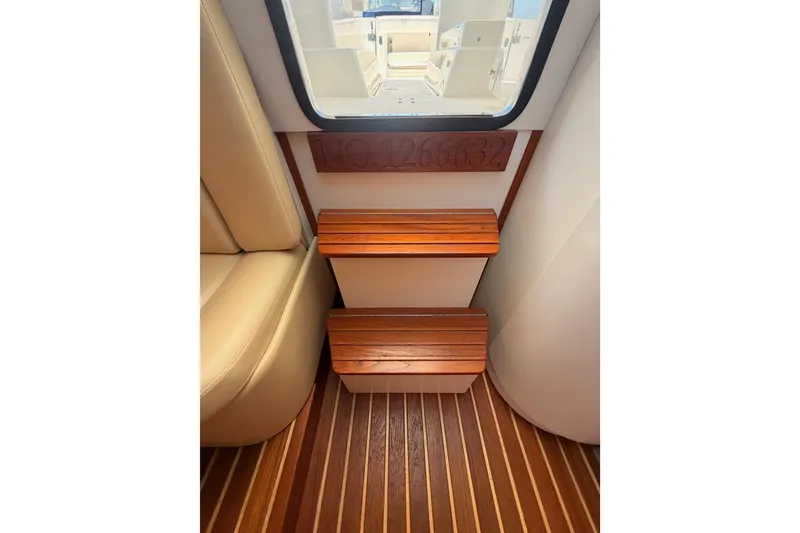 Slide: The Image of Interior of 2005 Tiara Yachts 2900 Open Classic, featuring wooden steps and seating. - 55