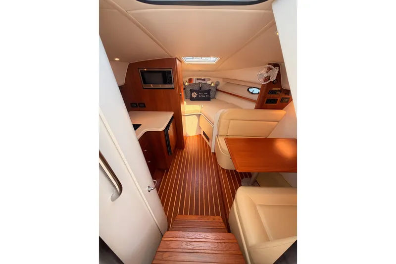 Slide: The Image of Interior of 2005 Tiara Yachts 2900 Open Classic, featuring wood flooring and cozy seating. - 44