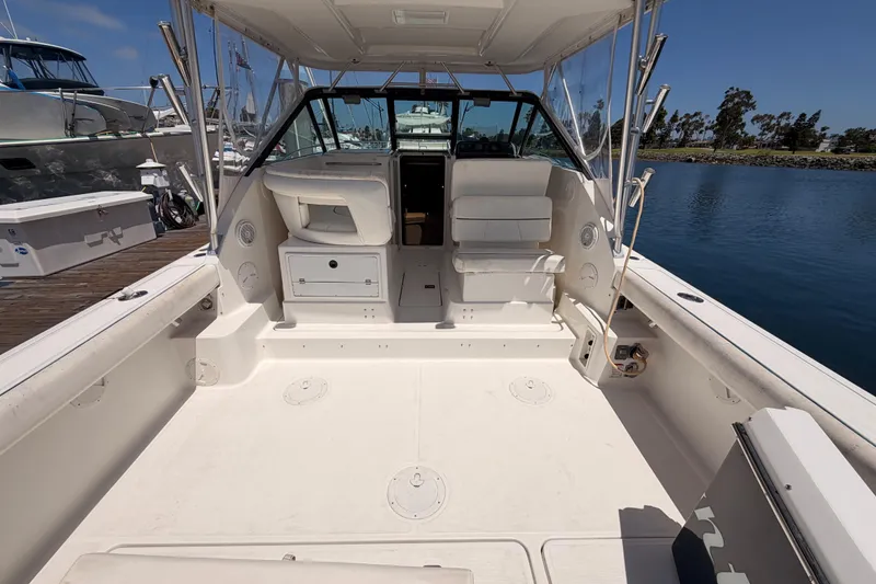 Slide: The Image of 2005 Tiara Yachts 2900 Open Classic boat interior, docked by calm waters. - 10