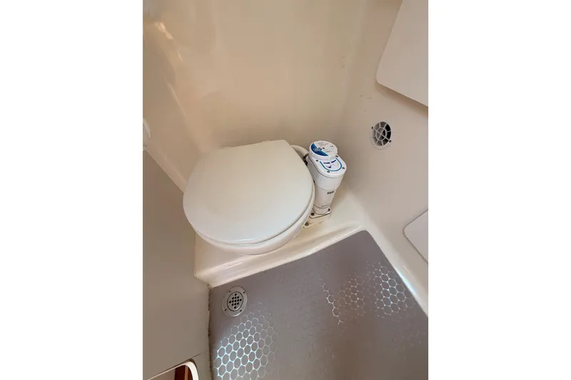 Slide: The Image of 2005 Tiara Yachts 2900 Open Classic bathroom with compact marine toilet. - 52