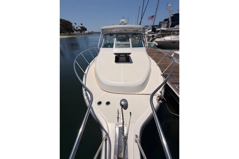 Slide: The Image of 2005 Tiara Yachts 2900 Open Classic docked, showcasing sleek design and spacious deck. - 22