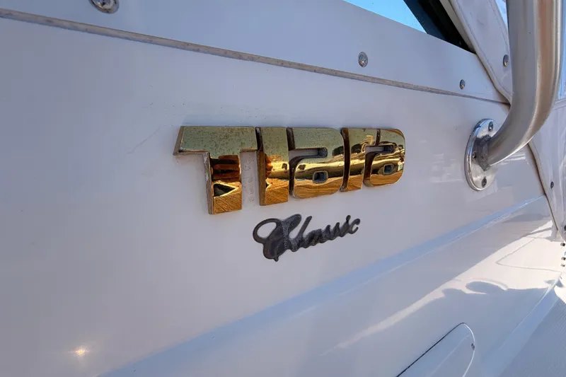 Slide: The Image of 2005 Tiara Yachts 2900 Open Classic logo on white boat exterior. - 6
