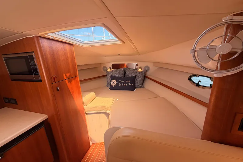 Slide: The Image of 2005 Tiara Yachts 2900 Open Classic cabin interior with cozy seating and nautical decor. - 64