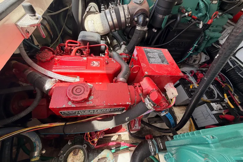 Slide: The Image of Engine compartment of a 2005 Tiara Yachts 2900 Open Classic, featuring a red Westerbeke generator. - 79