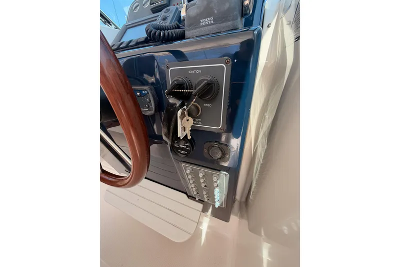 Slide: The Image of 2005 Tiara Yachts 2900 Open Classic dashboard with ignition and keys. - 32