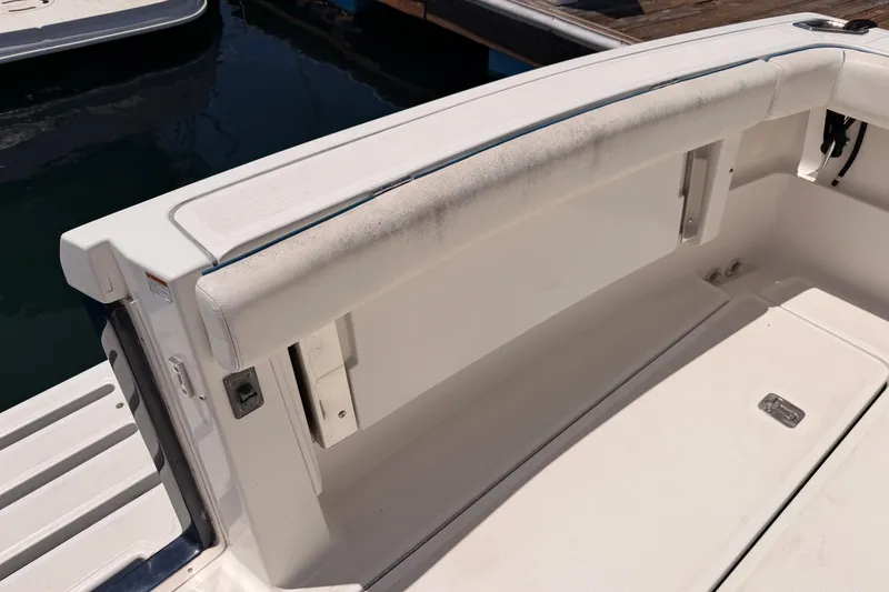 Slide: The Image of 2005 Tiara Yachts 2900 Open Classic boat interior, featuring clean seating and storage area. - 75