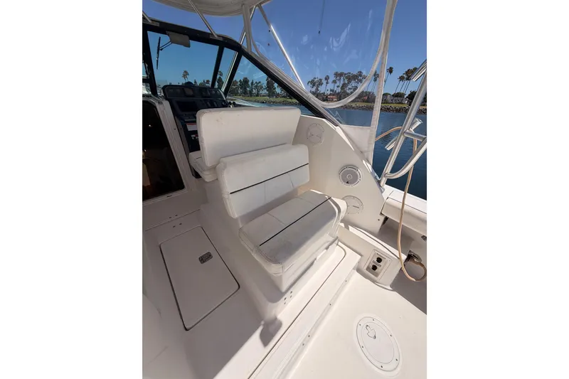 Slide: The Image of 2005 Tiara Yachts 2900 Open Classic cockpit with white seating and clear canopy. - 27