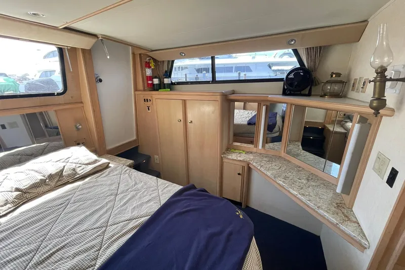 Slide: The Image of Interior of 1990 Tollycraft 34 Sport Sedan with cozy bedroom and wooden cabinetry. - 8