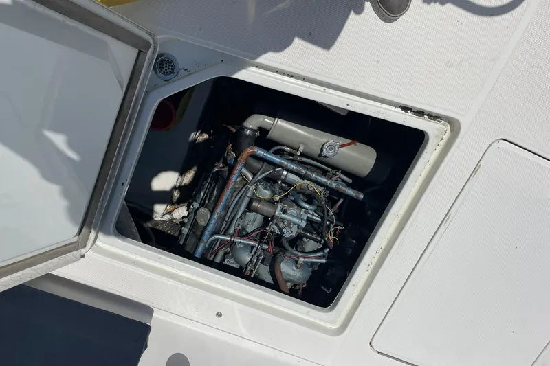 Slide: The Image of Engine compartment of a 1990 Tollycraft 34 Sport Sedan boat, showing mechanical components. - 49