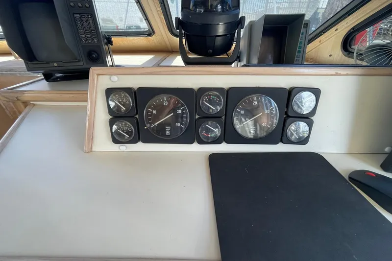 Slide: The Image of Dashboard of a 1990 Tollycraft 34 Sport Sedan with gauges and navigation equipment. - 40