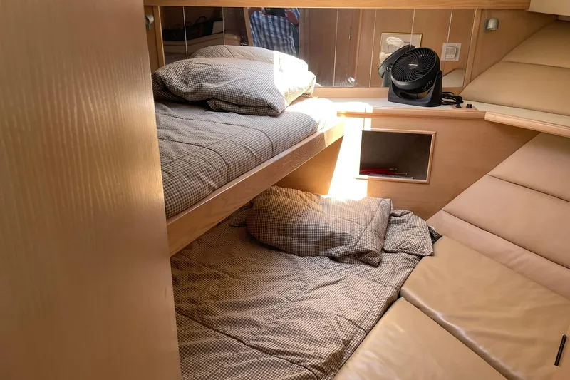 Slide: The Image of Interior cabin of 1990 Tollycraft 34 Sport Sedan with bunk beds and fan. - 15