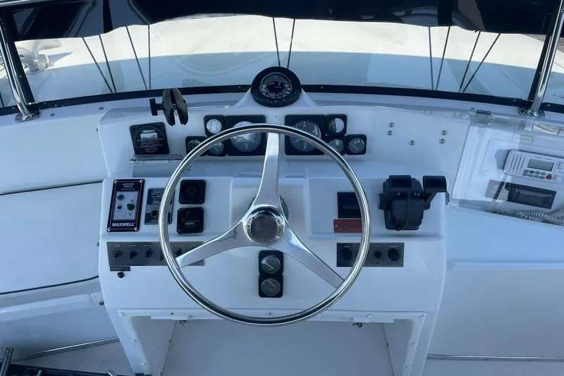 Slide: The Image of Cockpit of 1990 Tollycraft 34 Sport Sedan with steering wheel and control panel. - 43
