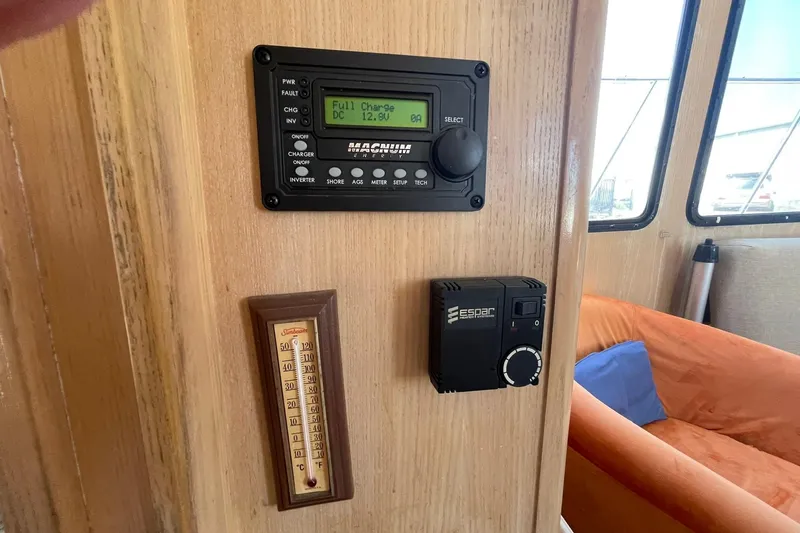 Slide: The Image of Control panel and thermometer inside 1990 Tollycraft 34 Sport Sedan boat cabin. - 19