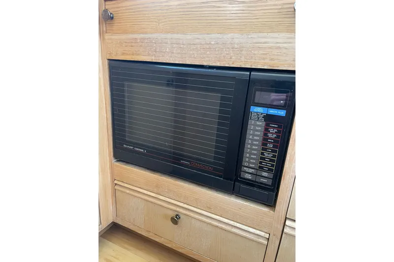 Slide: The Image of Built-in microwave in 1990 Tollycraft 34 Sport Sedan, featuring convection settings. - 25