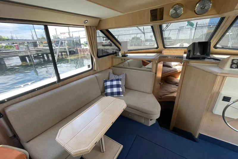 Slide: The Image of Interior of 1990 Tollycraft 34 Sport Sedan with cozy seating and nautical decor. - 2