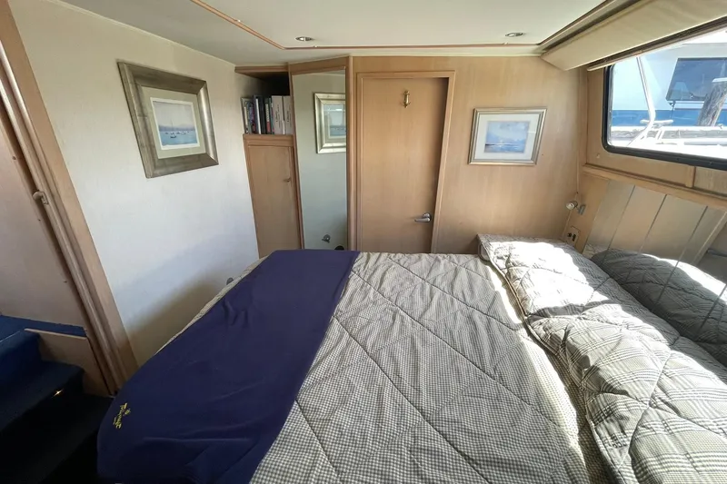 Slide: The Image of Cozy bedroom interior of 1990 Tollycraft 34 Sport Sedan yacht with nautical decor. - 9