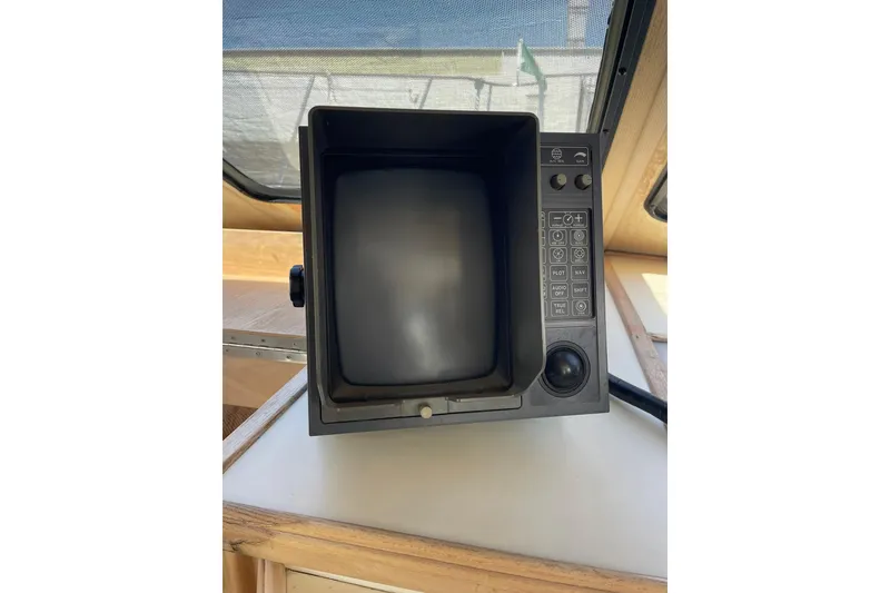 Slide: The Image of 1990 Tollycraft 34 Sport Sedan boat control panel with buttons and screen. - 28