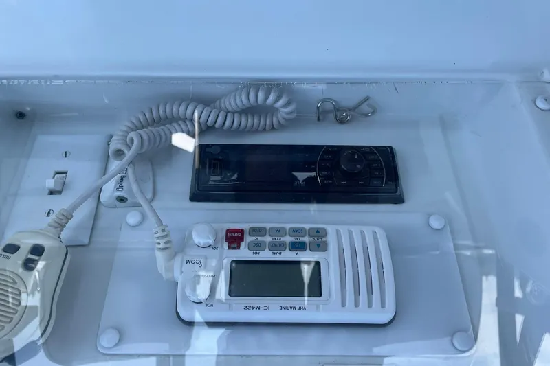 Slide: The Image of Control panel of a 1990 Tollycraft 34 Sport Sedan with marine radio and controls. - 46