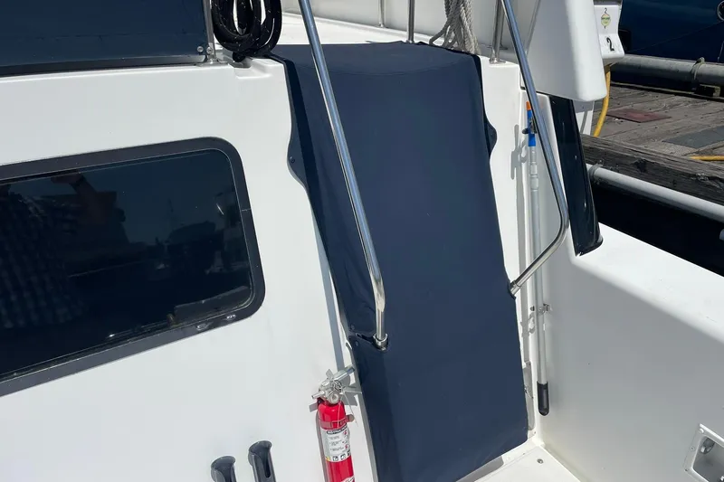 Slide: The Image of 1990 Tollycraft 34 Sport Sedan boat with blue cover and fire extinguisher. - 47