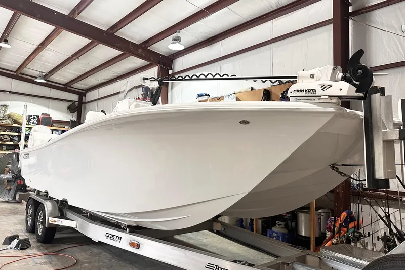 Slide: The Image of 2022 Costa Custom Boats 264HC on trailer in a storage facility. - 6