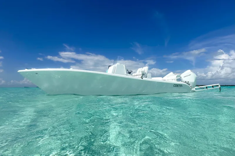 Slide: The Image of 2022 Costa Custom Boats 264HC on clear turquoise water under a vibrant blue sky. - 5