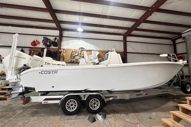 Slide: The Image of 2022 Costa Custom Boats 264HC on trailer in indoor storage facility. - 2